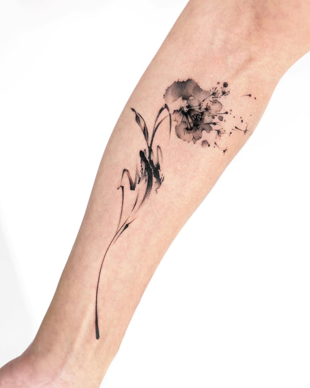 Elegant black watercolor dandelion tattoo design