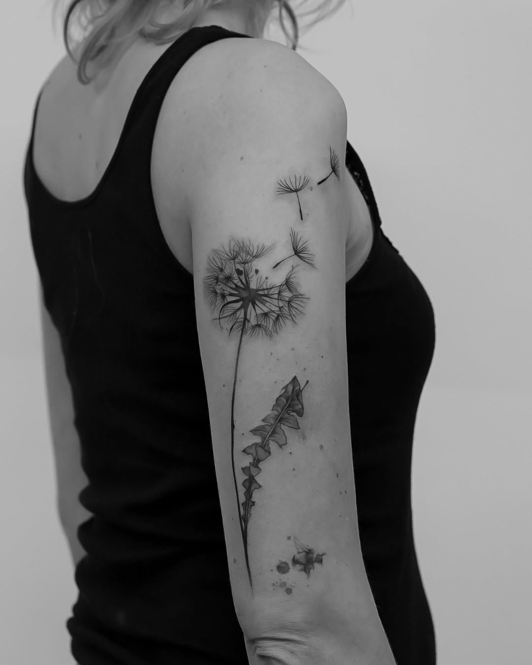 Elegant black and white dandelion tattoo design