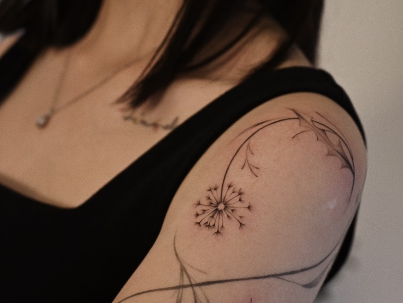 Delicate dandelion tattoo on the arm