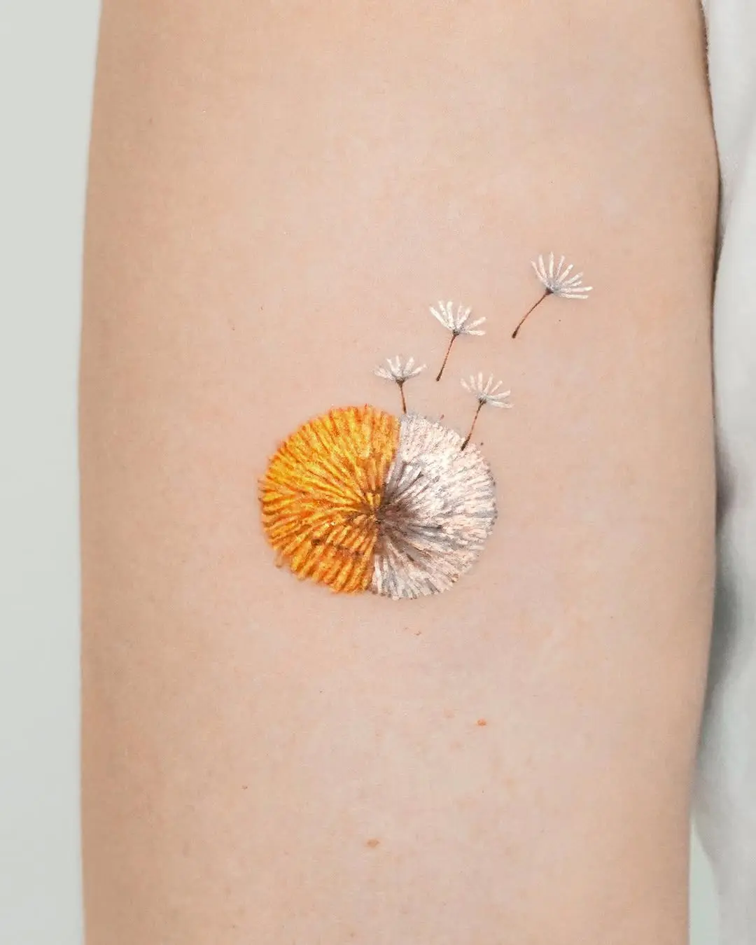 Stunning embroidered dandelion tattoo design