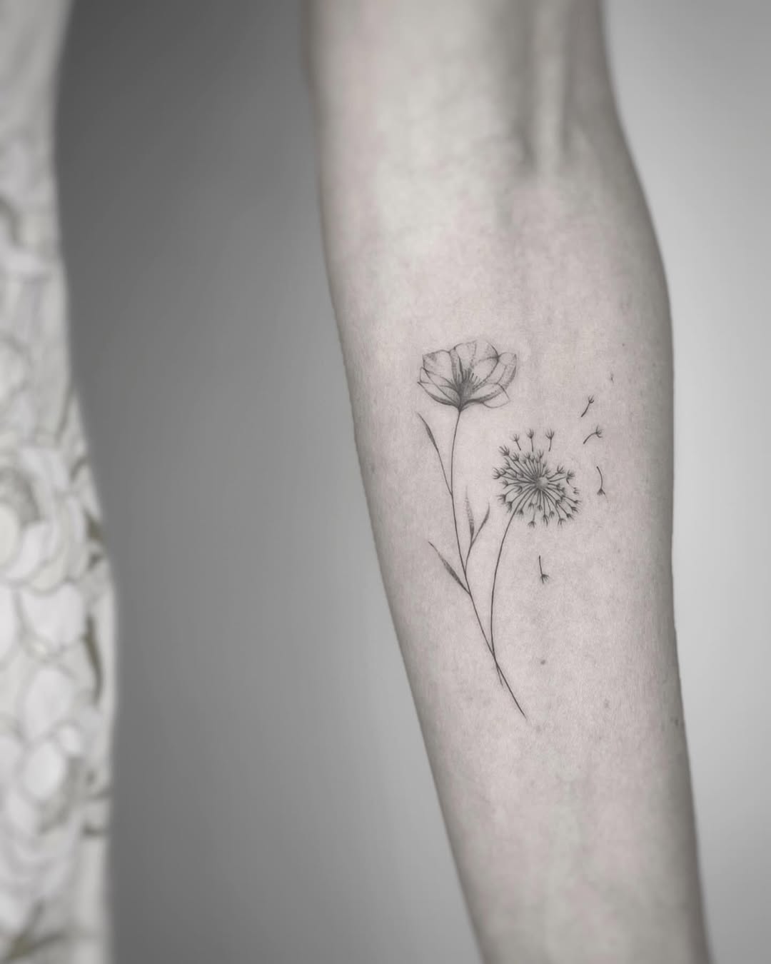 Elegant dandelion tattoo with delicate flower details