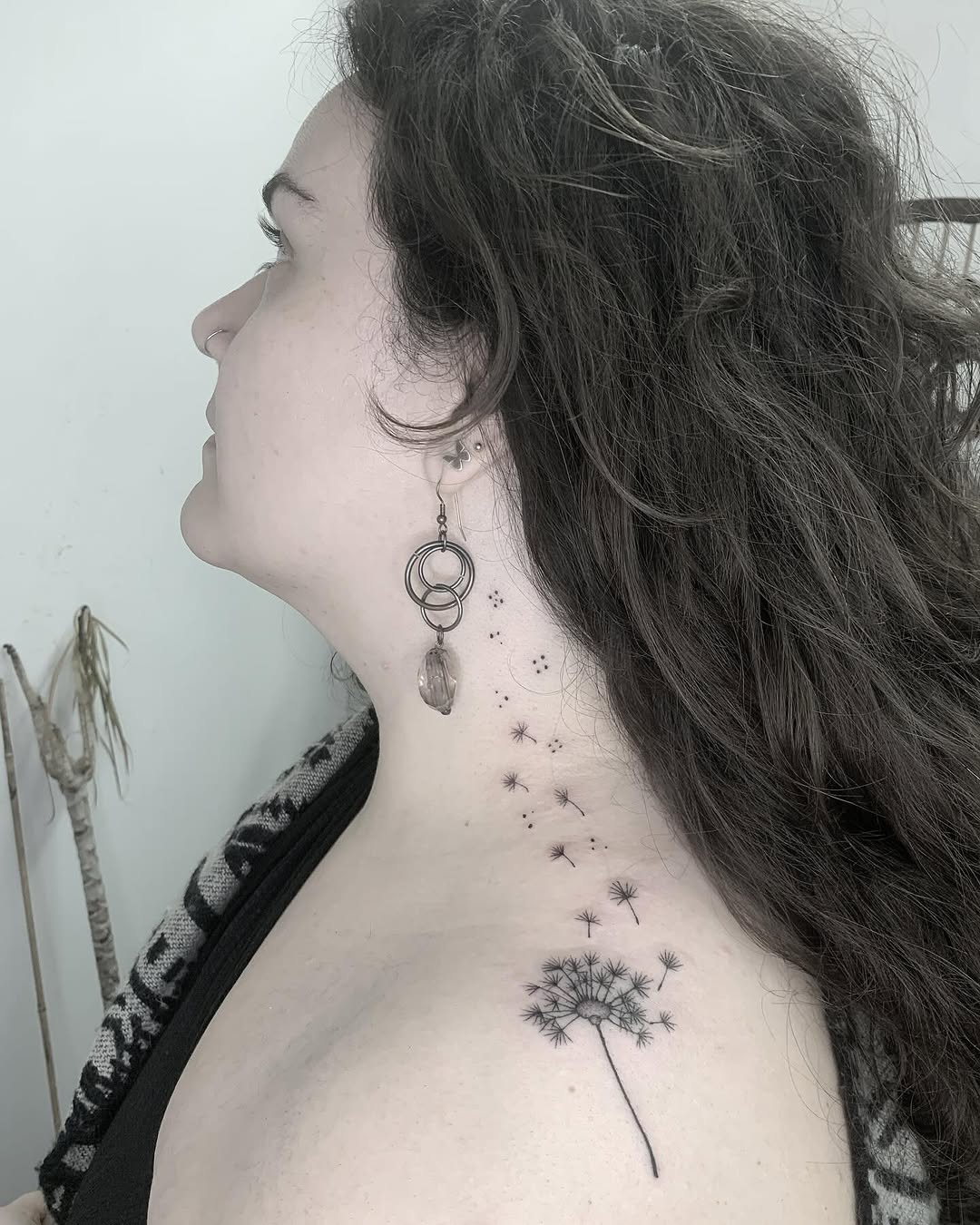 Elegant dandelion tattoo cascading down the neck