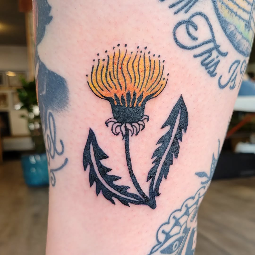 Vibrant dandelion tattoo with intricate detailing