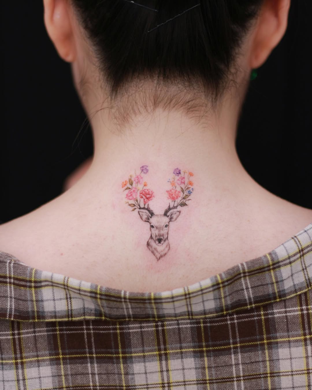 Elegant deer tattoo with floral antlers