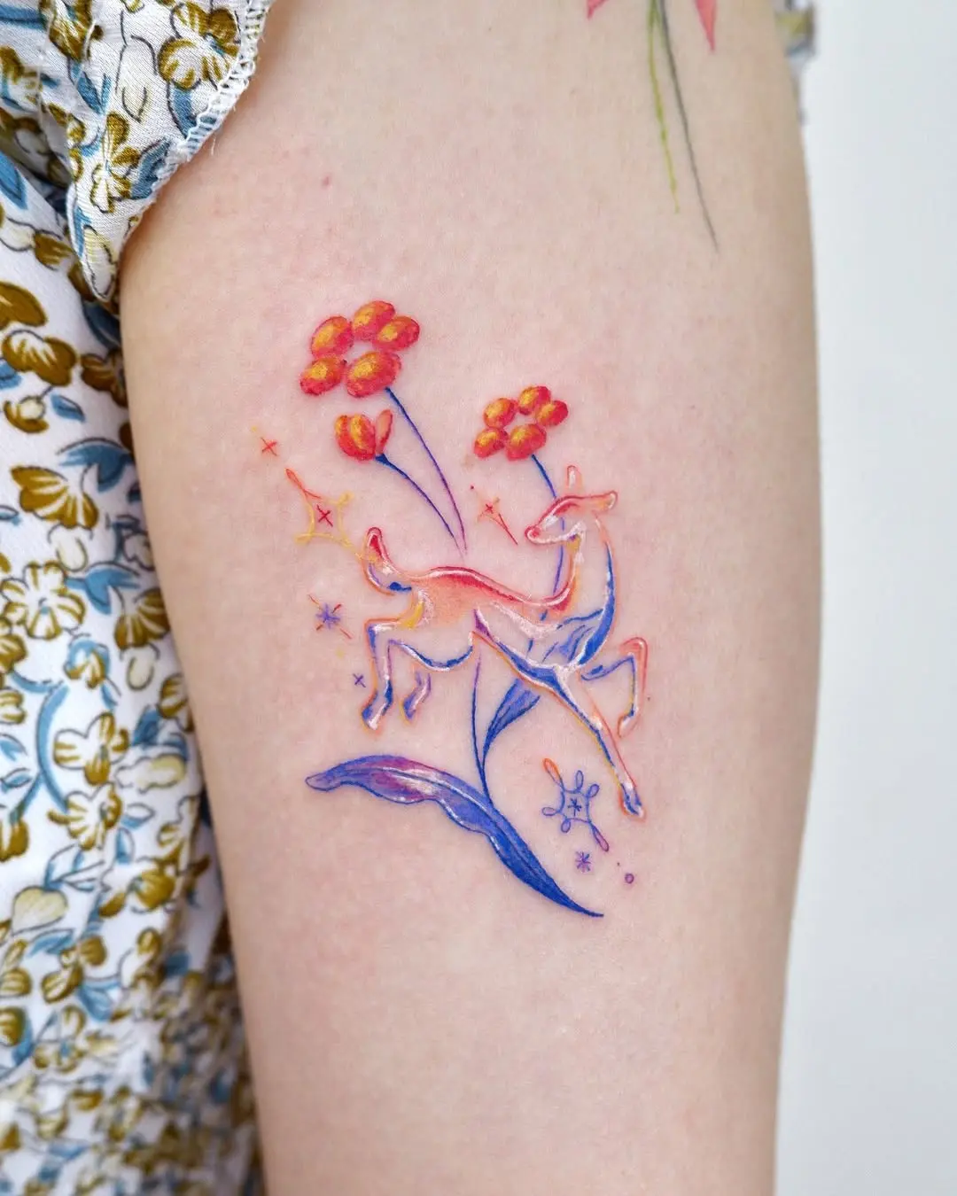 Colorful watercolor deer with floral accents