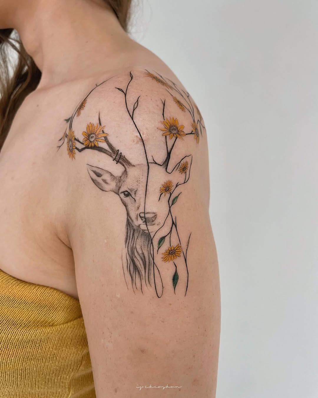 Feminine deer tattoo with beautiful floral elements