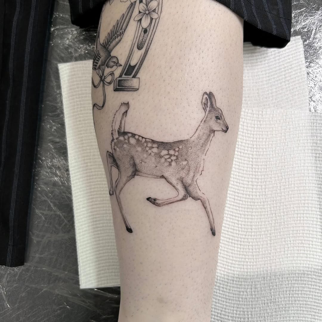 Elegant running deer tattoo on leg