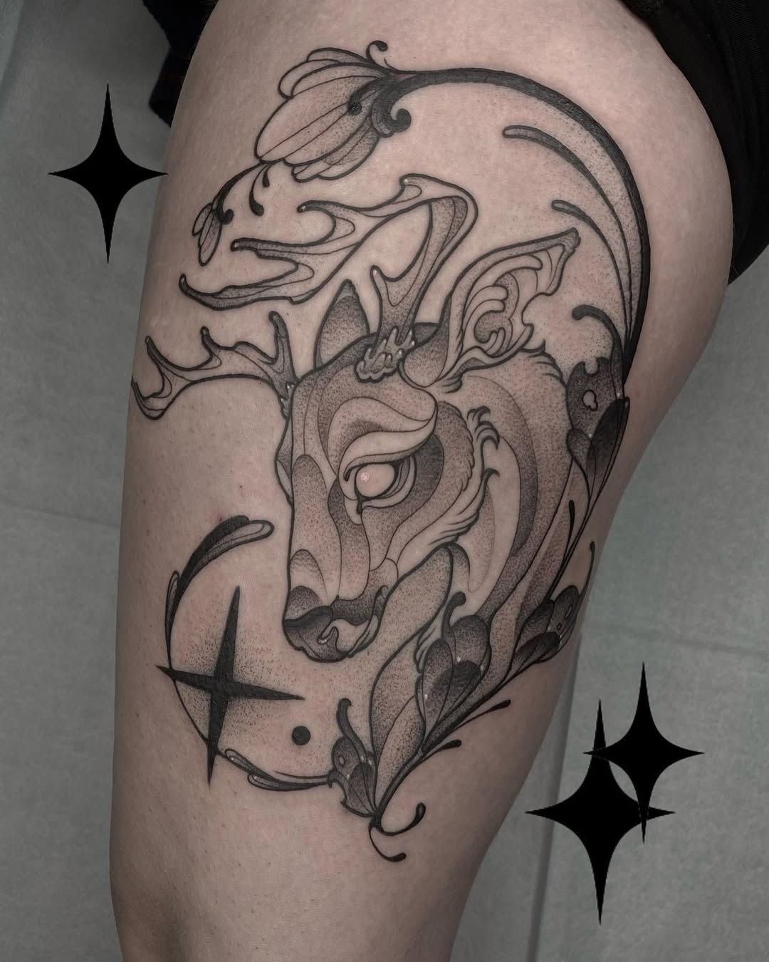 Elegant deer tattoo with floral elements