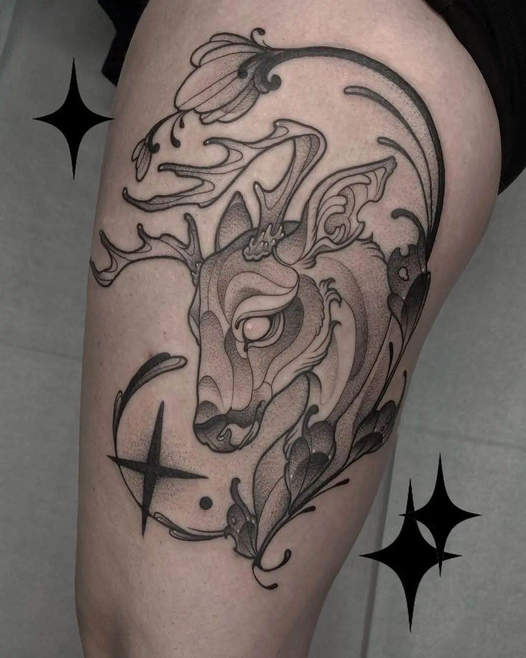 Elegant deer tattoo with floral elements
