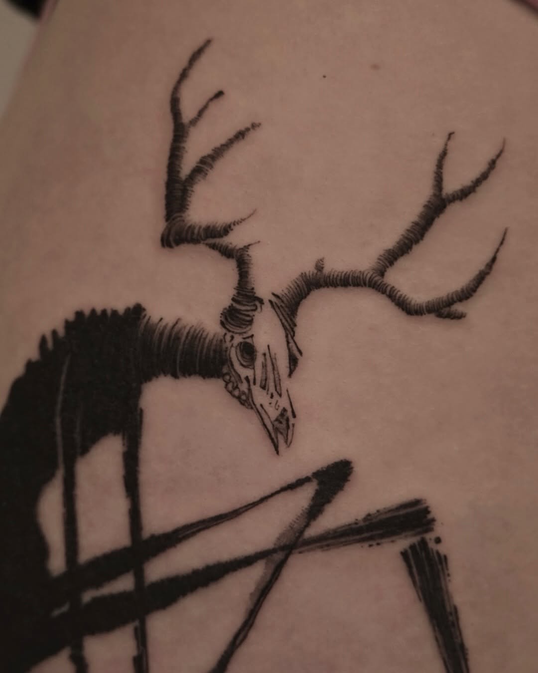 Intricate deer skull tattoo with abstract design