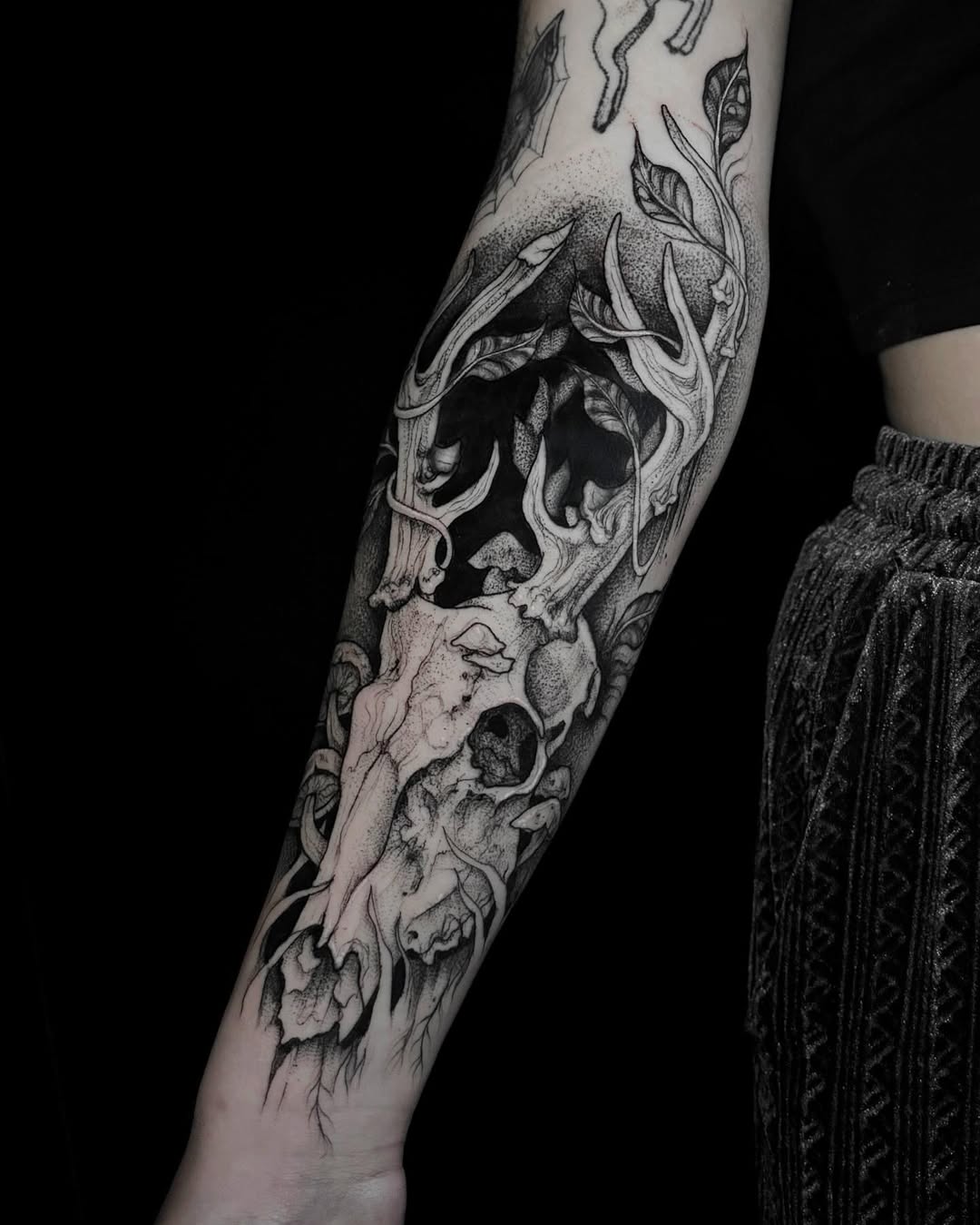 Elegant skull tattoo with floral accents