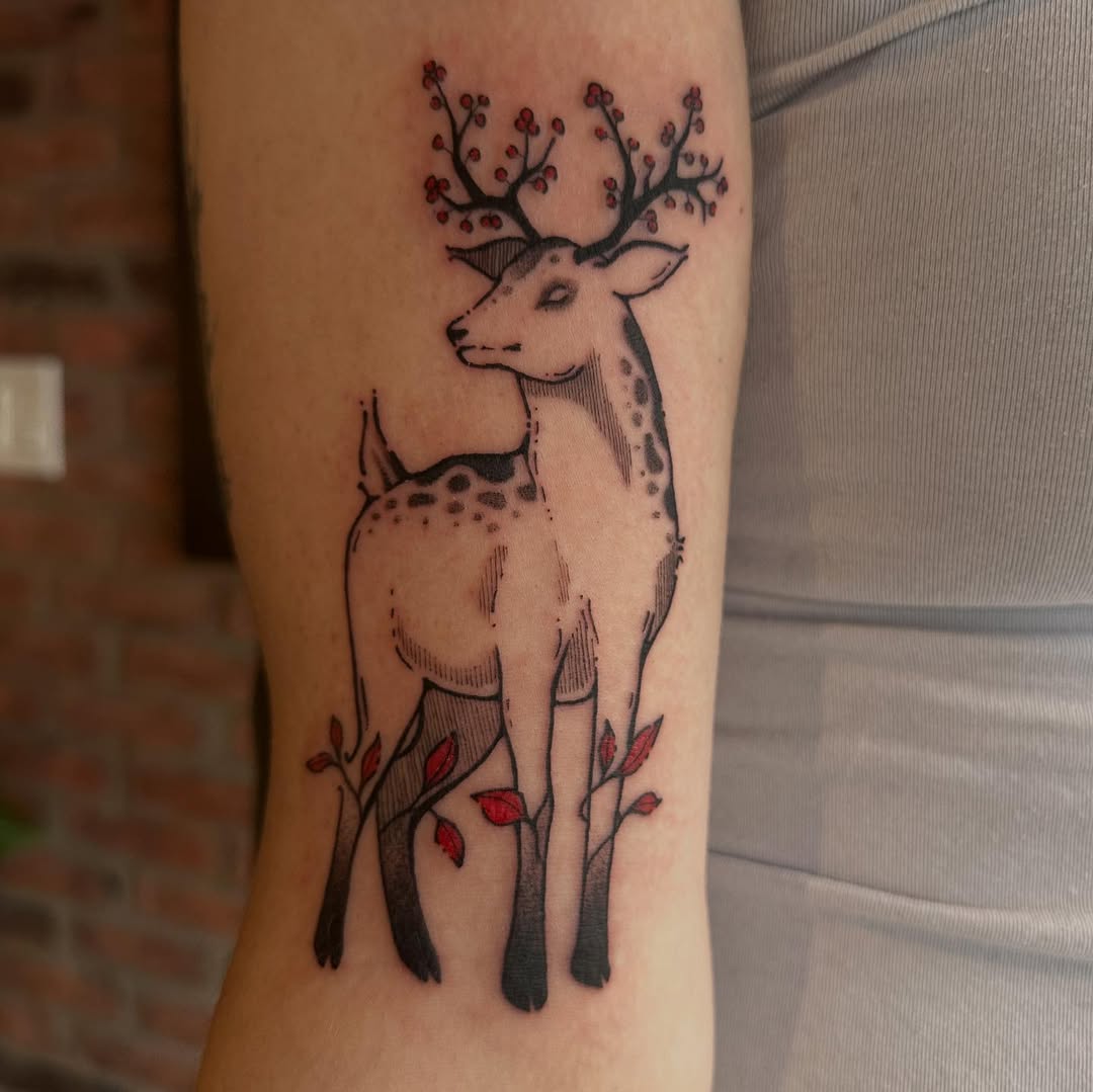 Elegant deer tattoo surrounded by floral elements