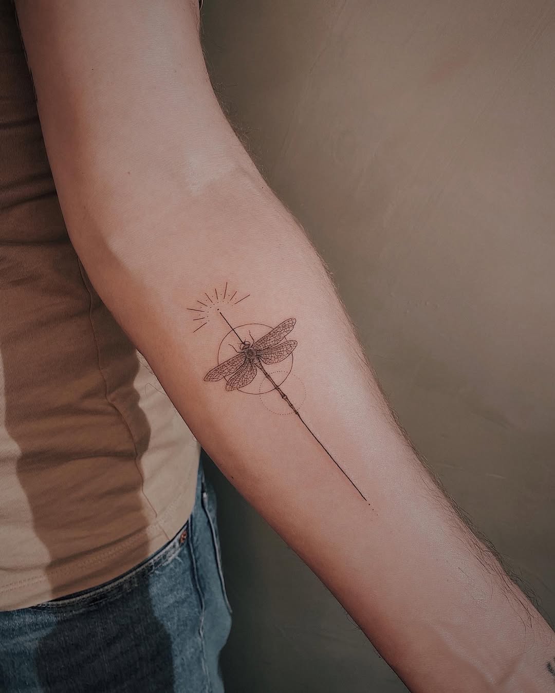 Minimalist Dragonfly Tattoo on Arm