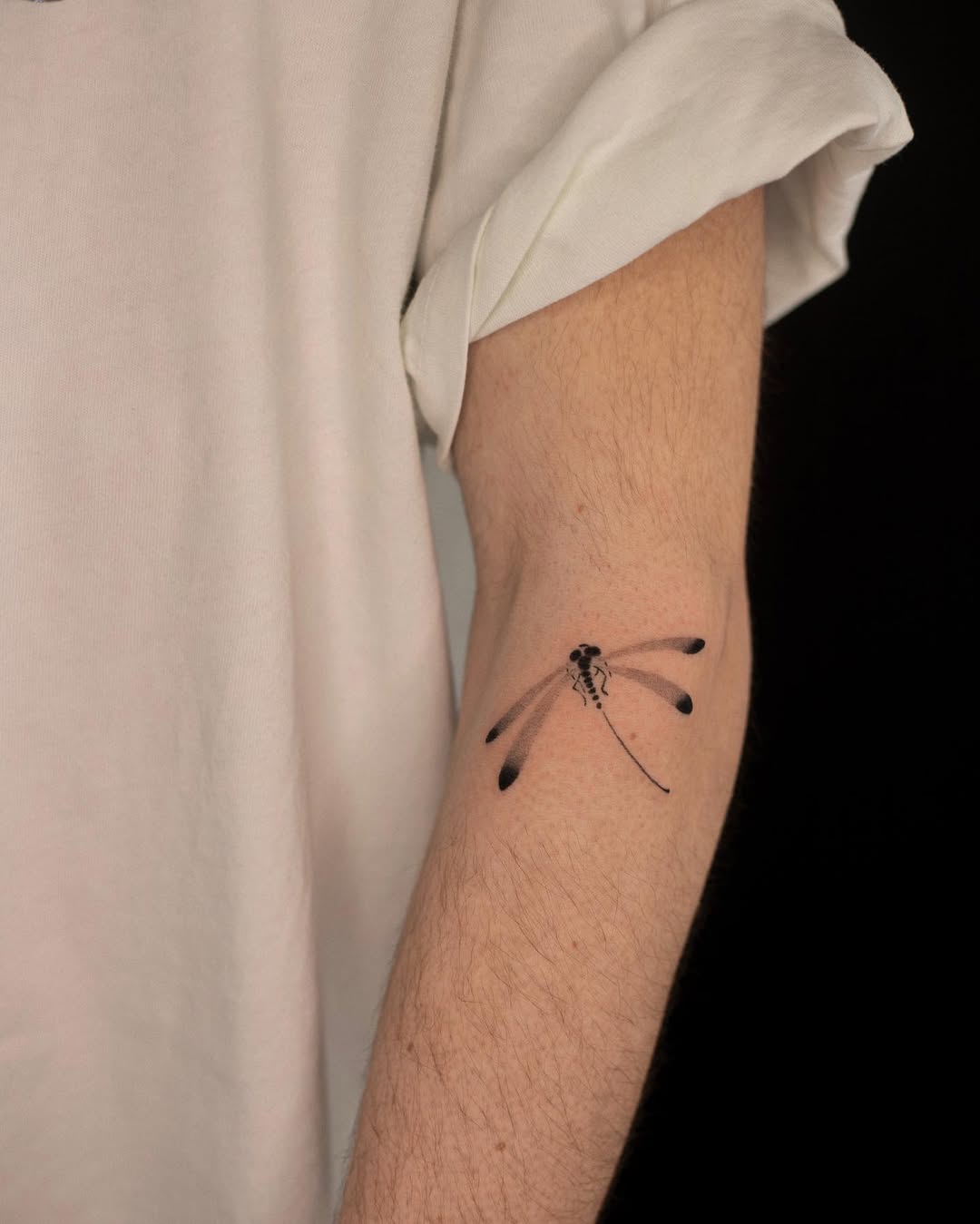 Elegant Dragonfly Tattoo on a Forearm