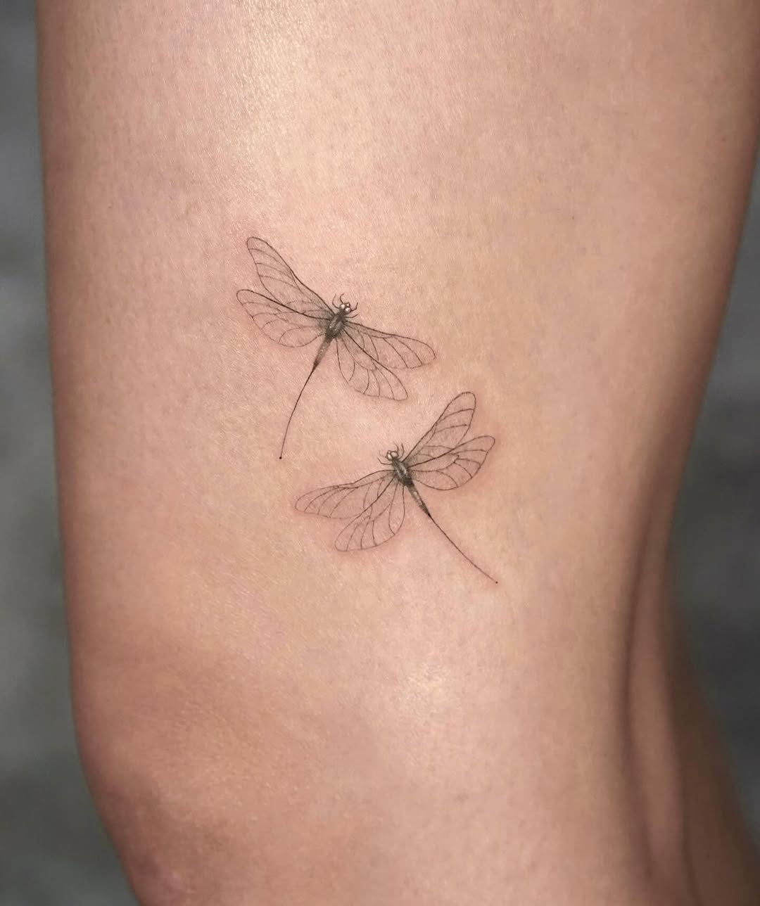 Intricate dragonfly tattoos on smooth skin