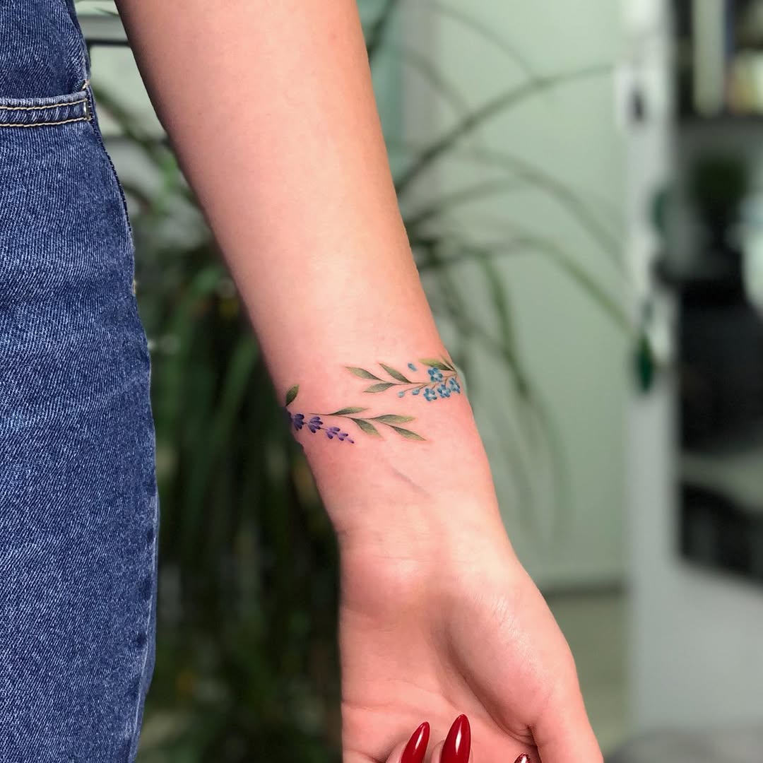 A vibrant floral bracelet tattoo on the wrist