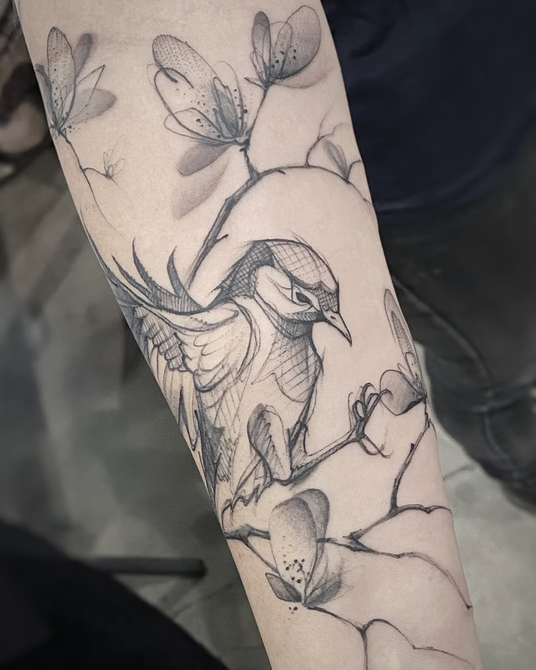 Elegant bird tattoo with floral elements