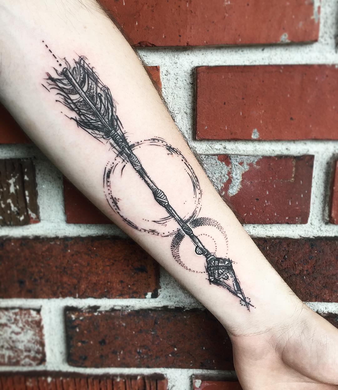 Intricate arrow tattoo with geometric elements