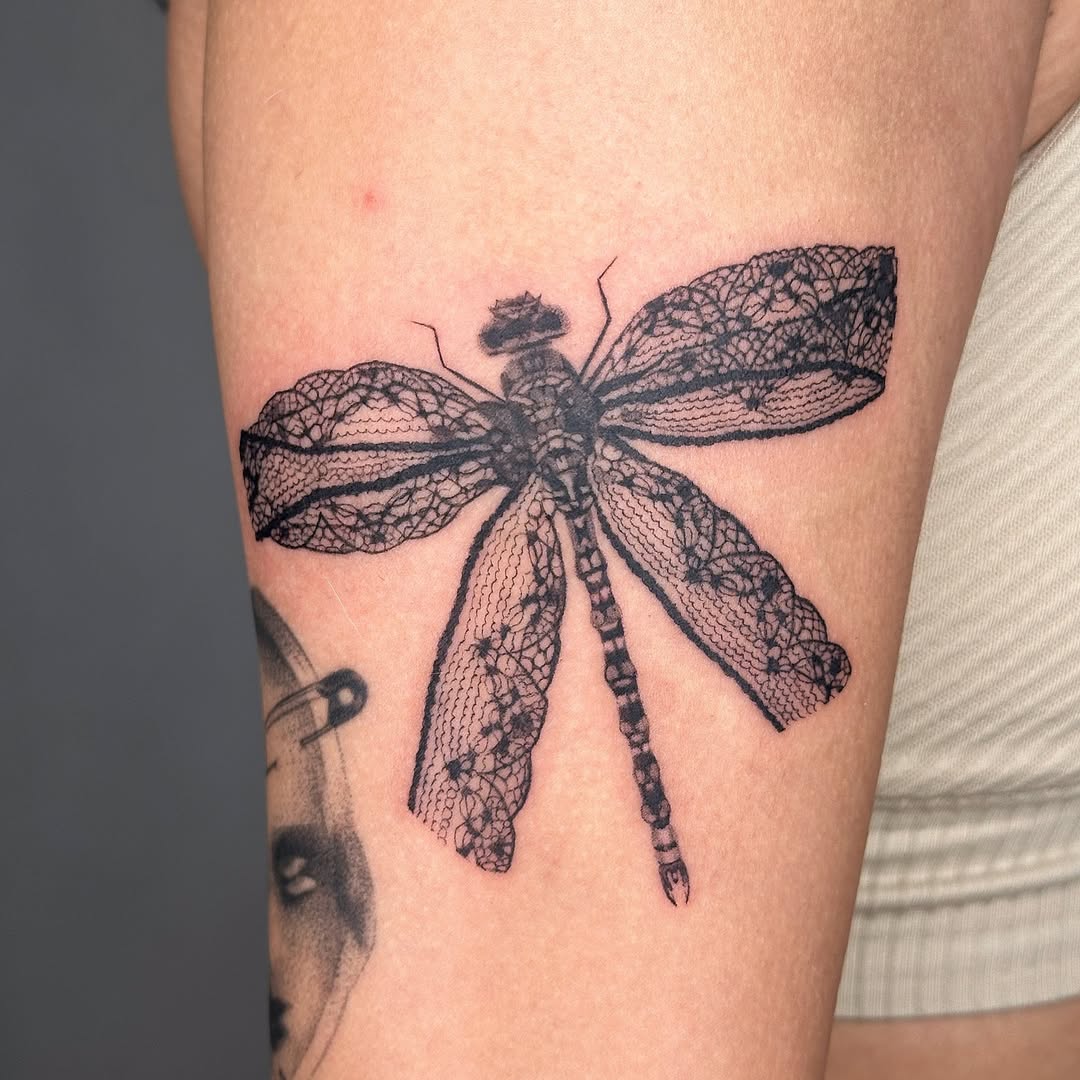 Intricate dragonfly tattoo with lace detailing