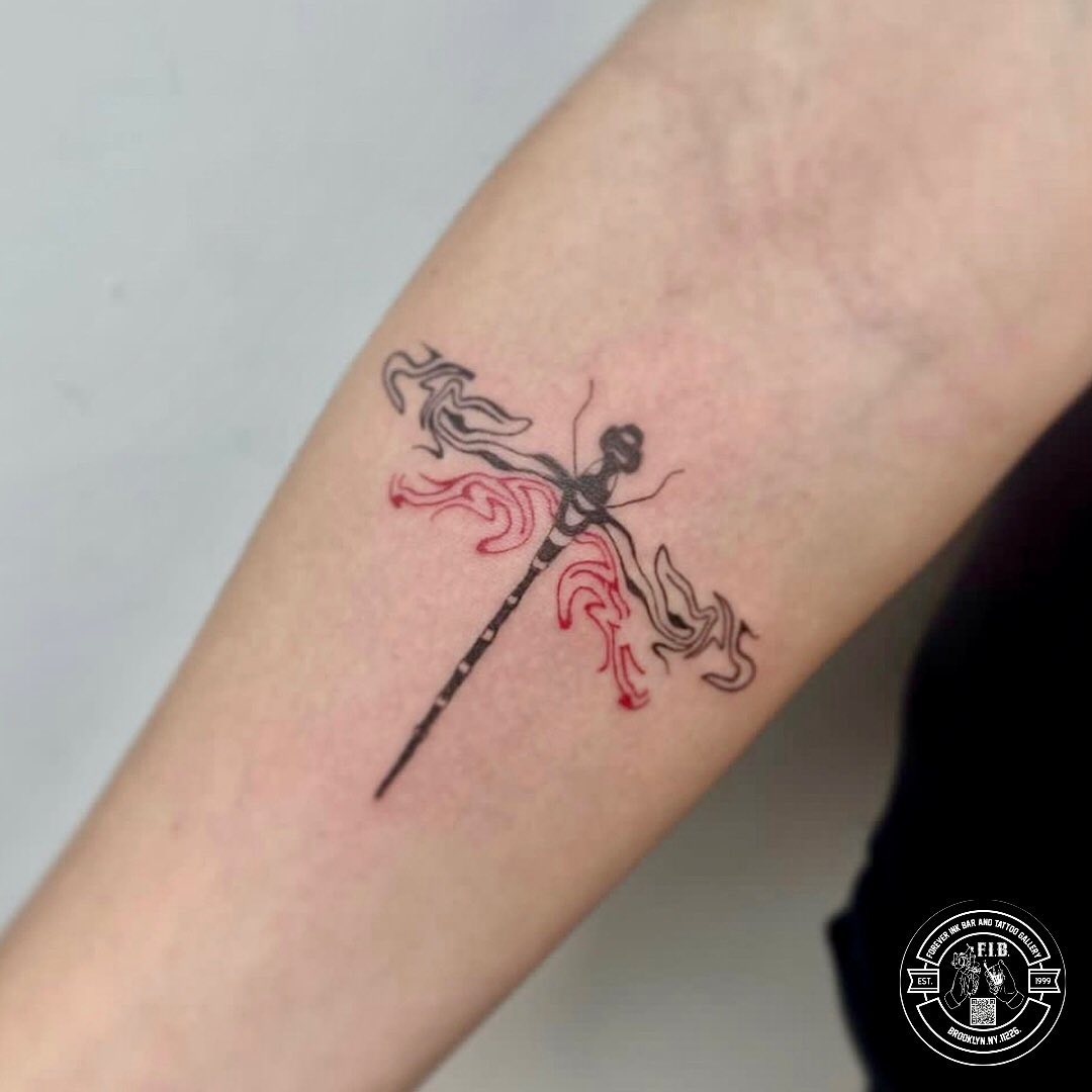 Elegant dragonfly tattoo blending color and design