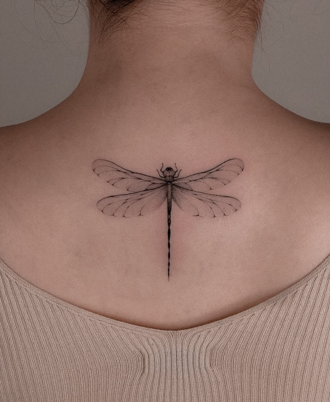 Elegant Dragonfly Tattoo on a Woman's Back