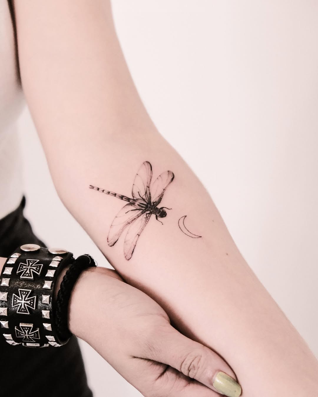 Elegant dragonfly tattoo with a crescent moon