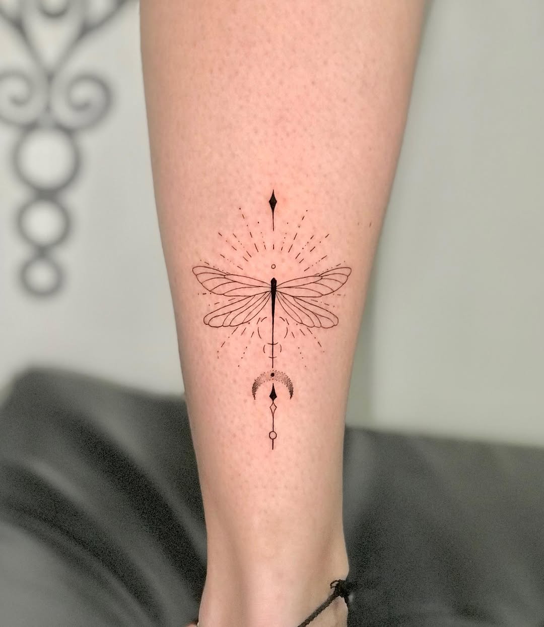 Elegant dragonfly tattoo with geometric elements