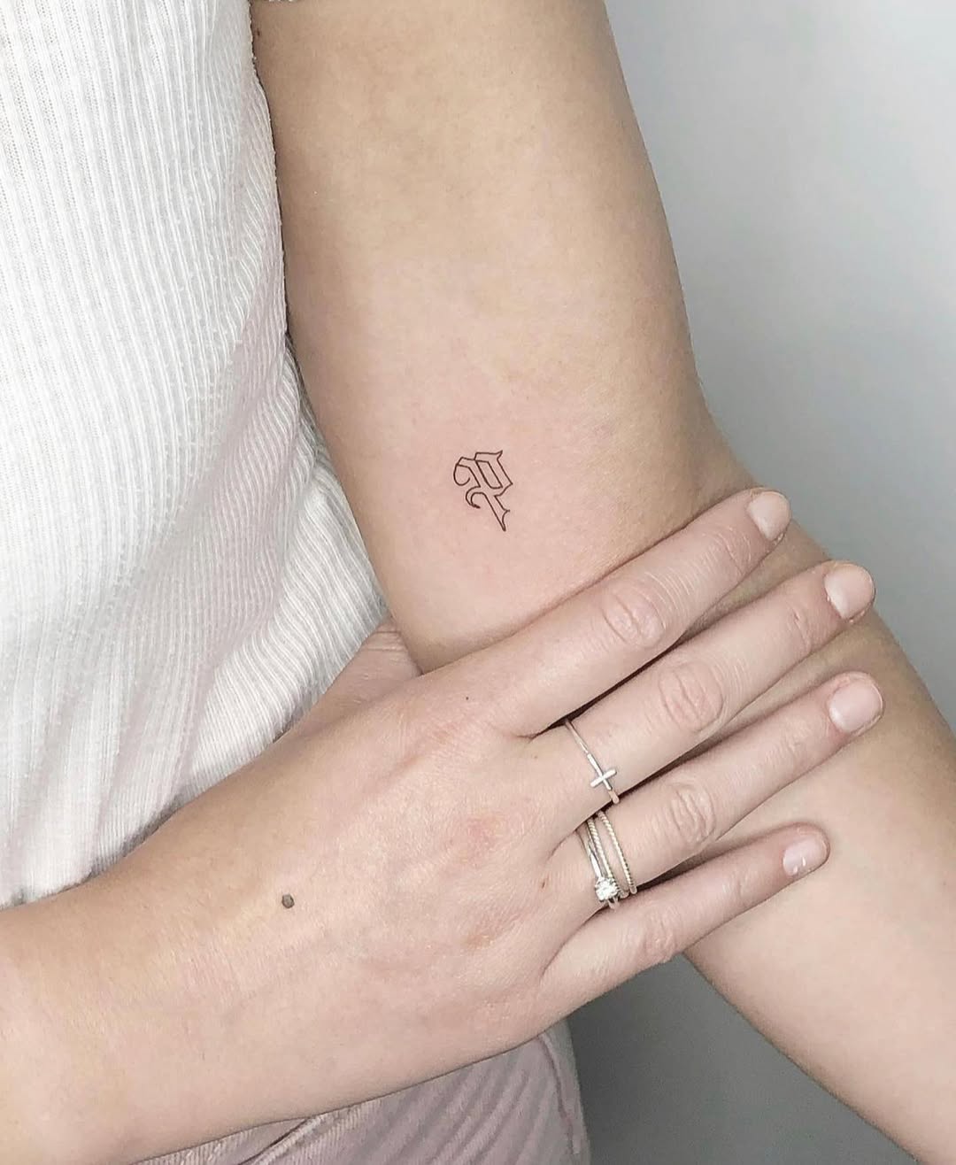 Stylish Initials Tattoo on a Woman's Arm