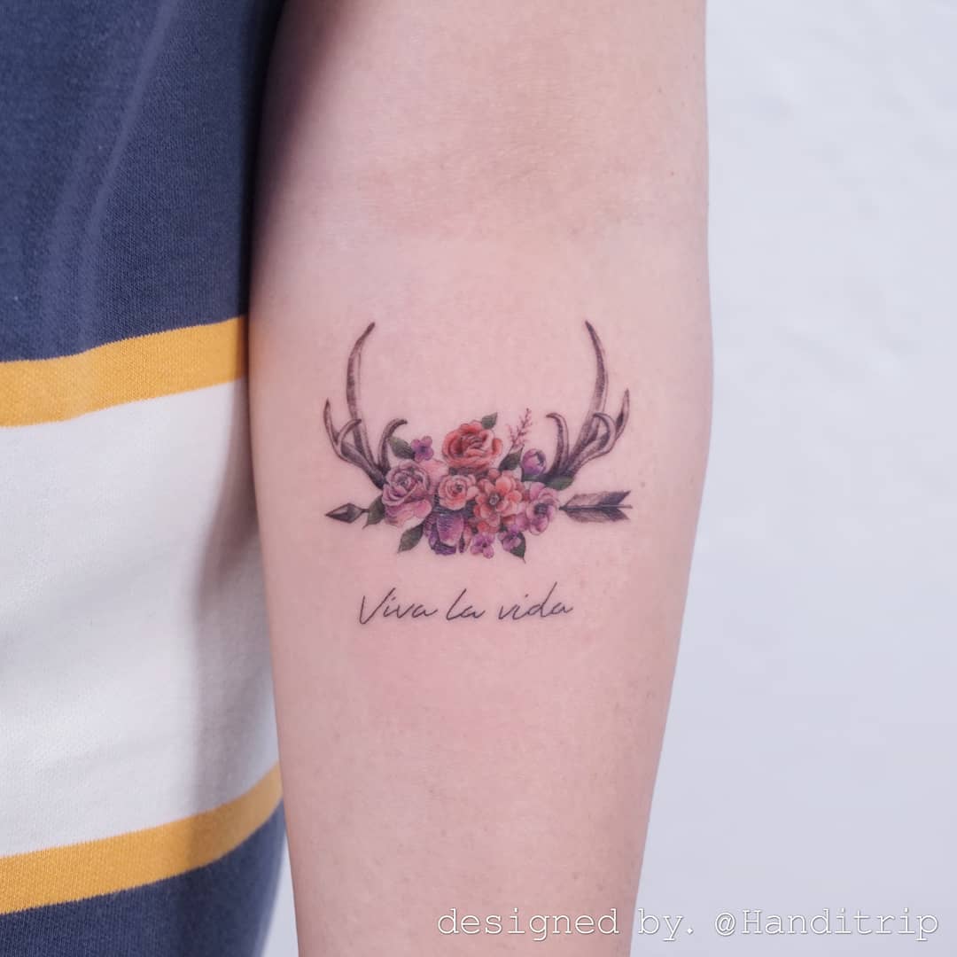 Elegant floral deer tattoo with a vibrant message