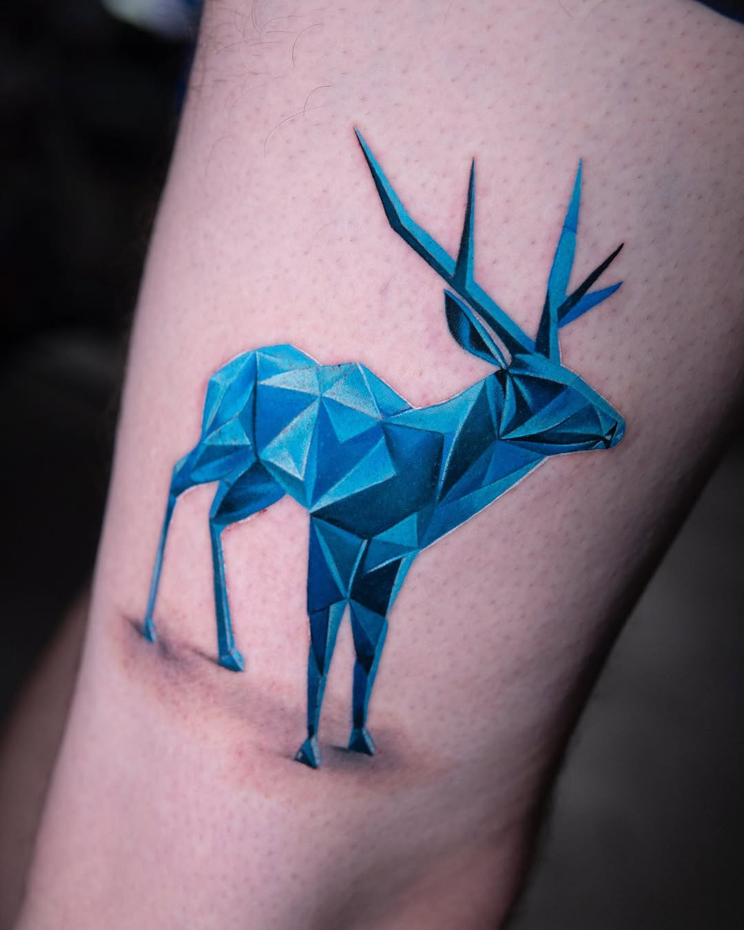 Stunning geometric deer tattoo in vibrant blue