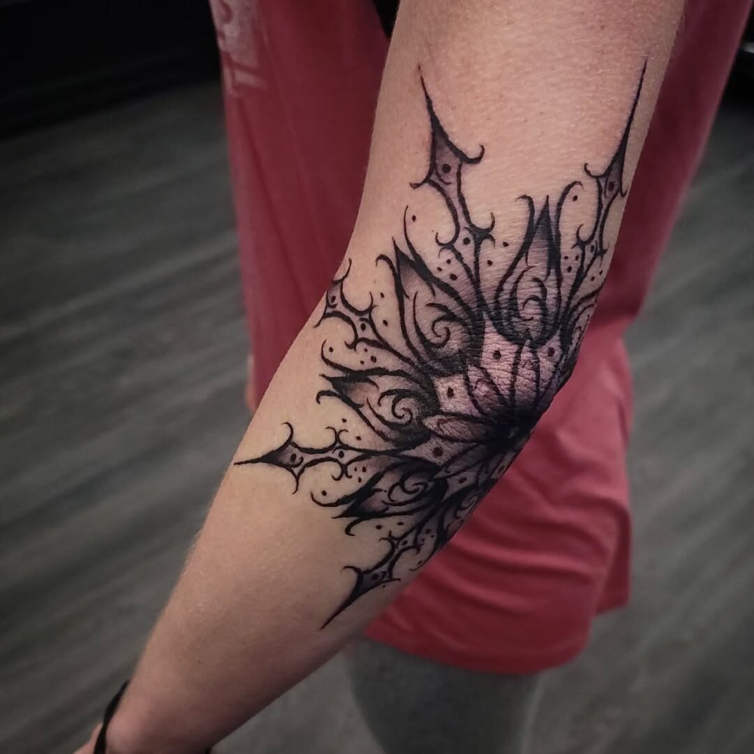 Intricate floral goth tattoo with dark elegance.