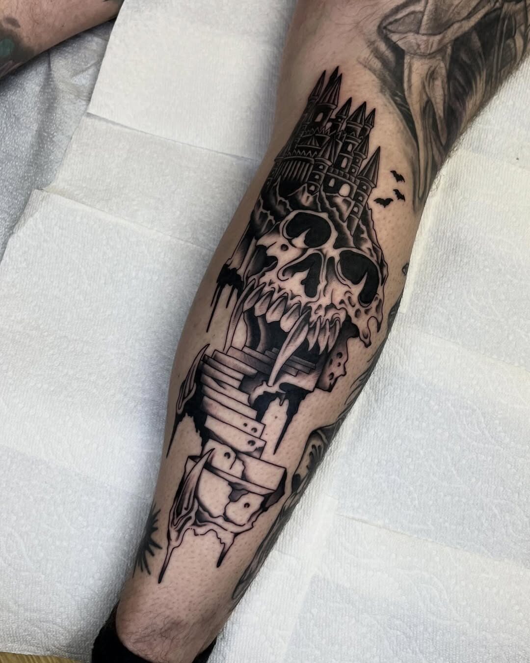 Gothic skull castle tattoo with dark elements