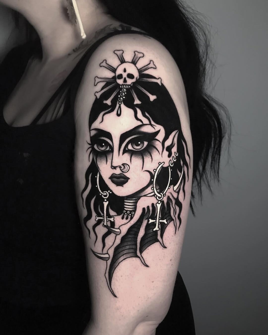 Dark feminine tattoo exuding gothic allure