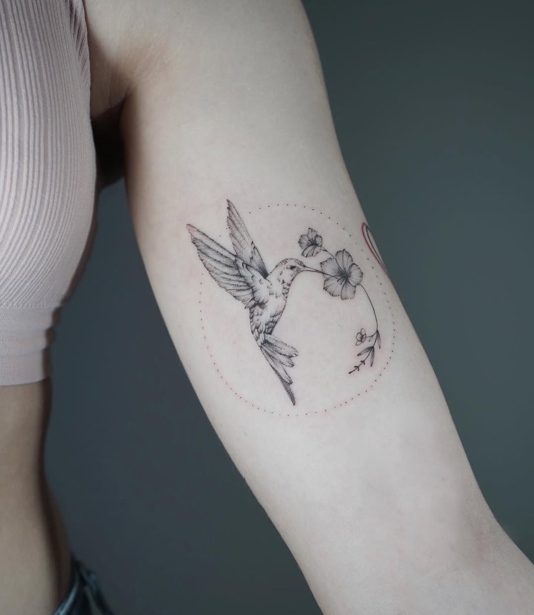 Elegant hummingbird with floral design tattoo