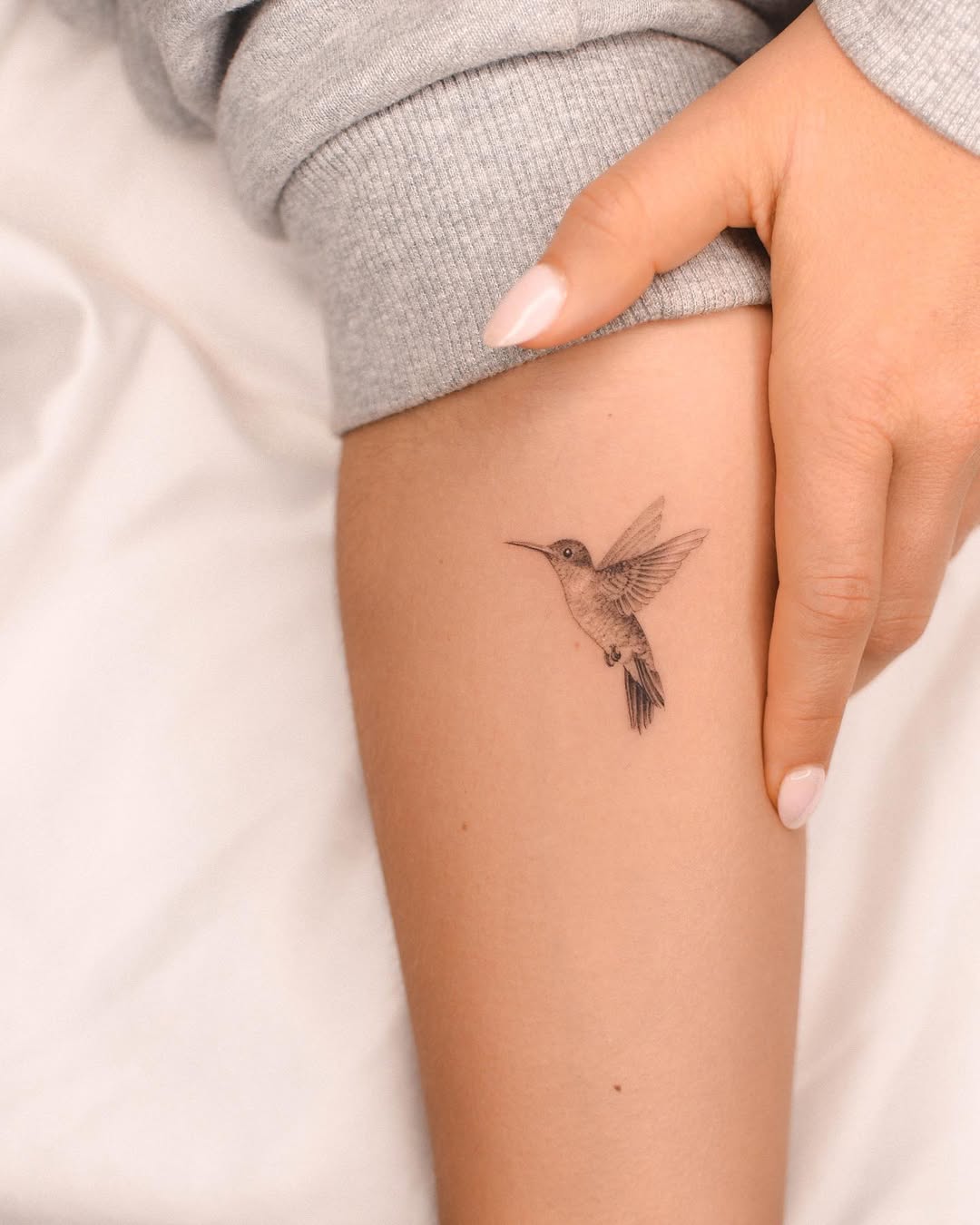 Elegant hummingbird tattoo in fine detail