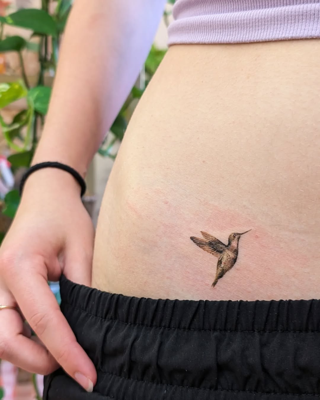 Delicate hummingbird tattoo on side rib