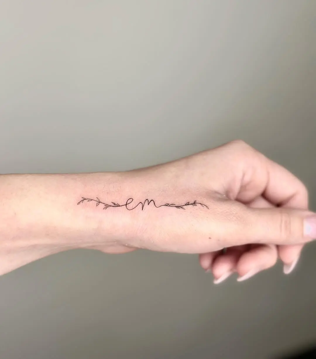 Elegant Initials Tattoo with Delicate Vines