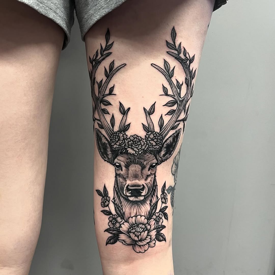 Elegant deer tattoo adorned with flowers