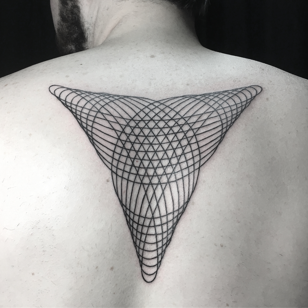 Intricate geometric tattoo in a triangular shape