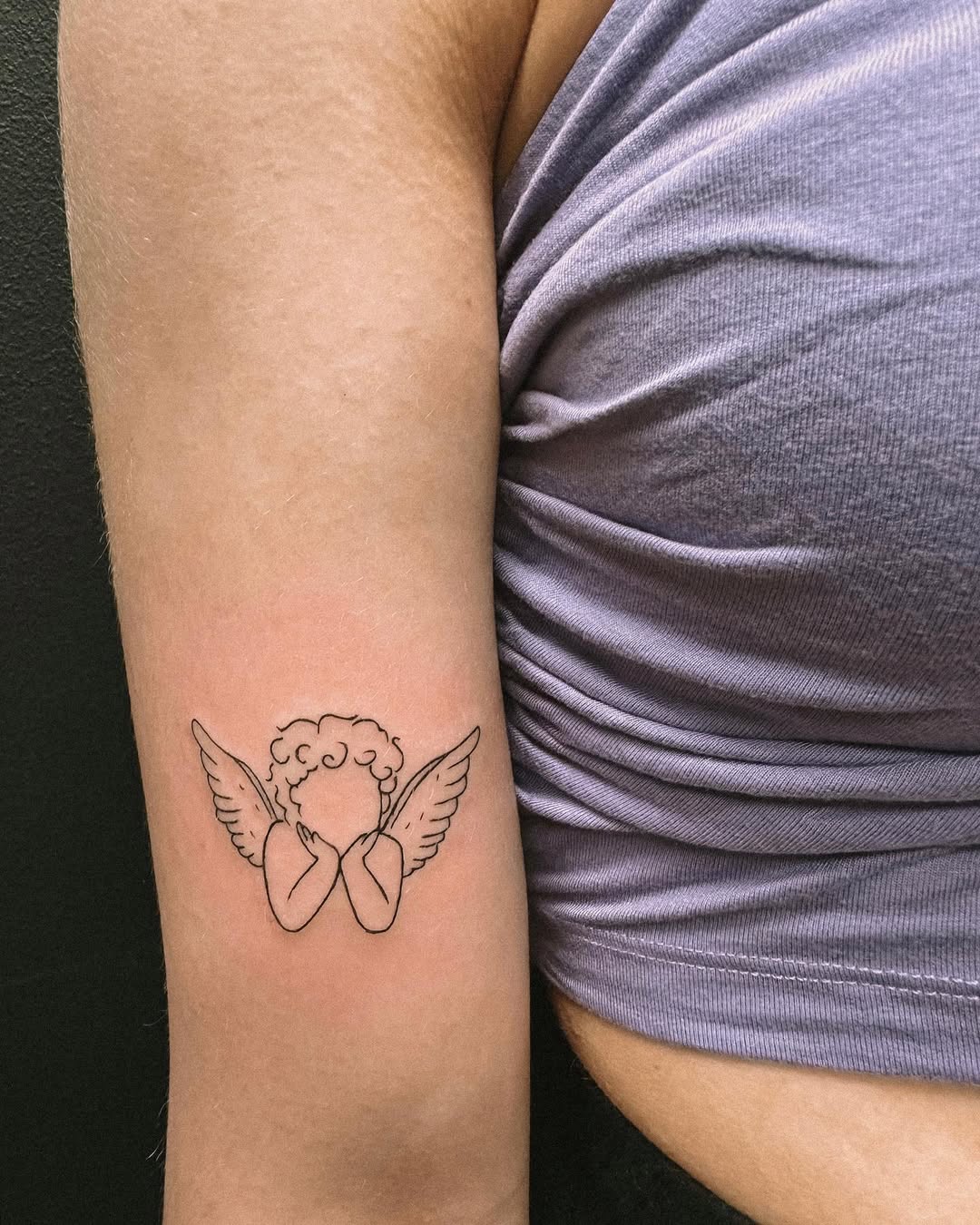 Delicate angel tattoo exuding soft elegance