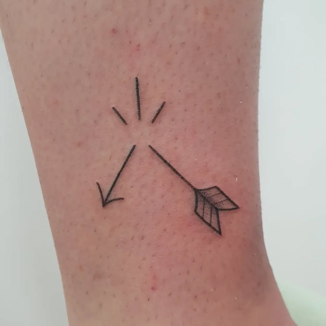 Stylish minimalist arrow tattoo on ankle