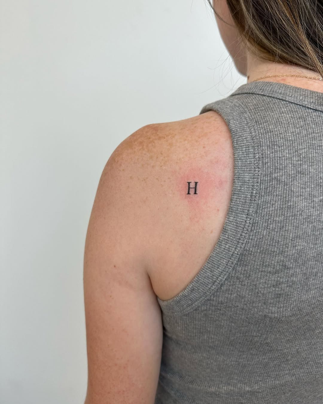 Simple Initial Tattoo on Upper Arm