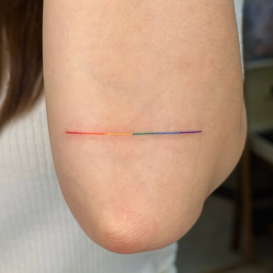 Minimalist Rainbow Tattoo on Elbow