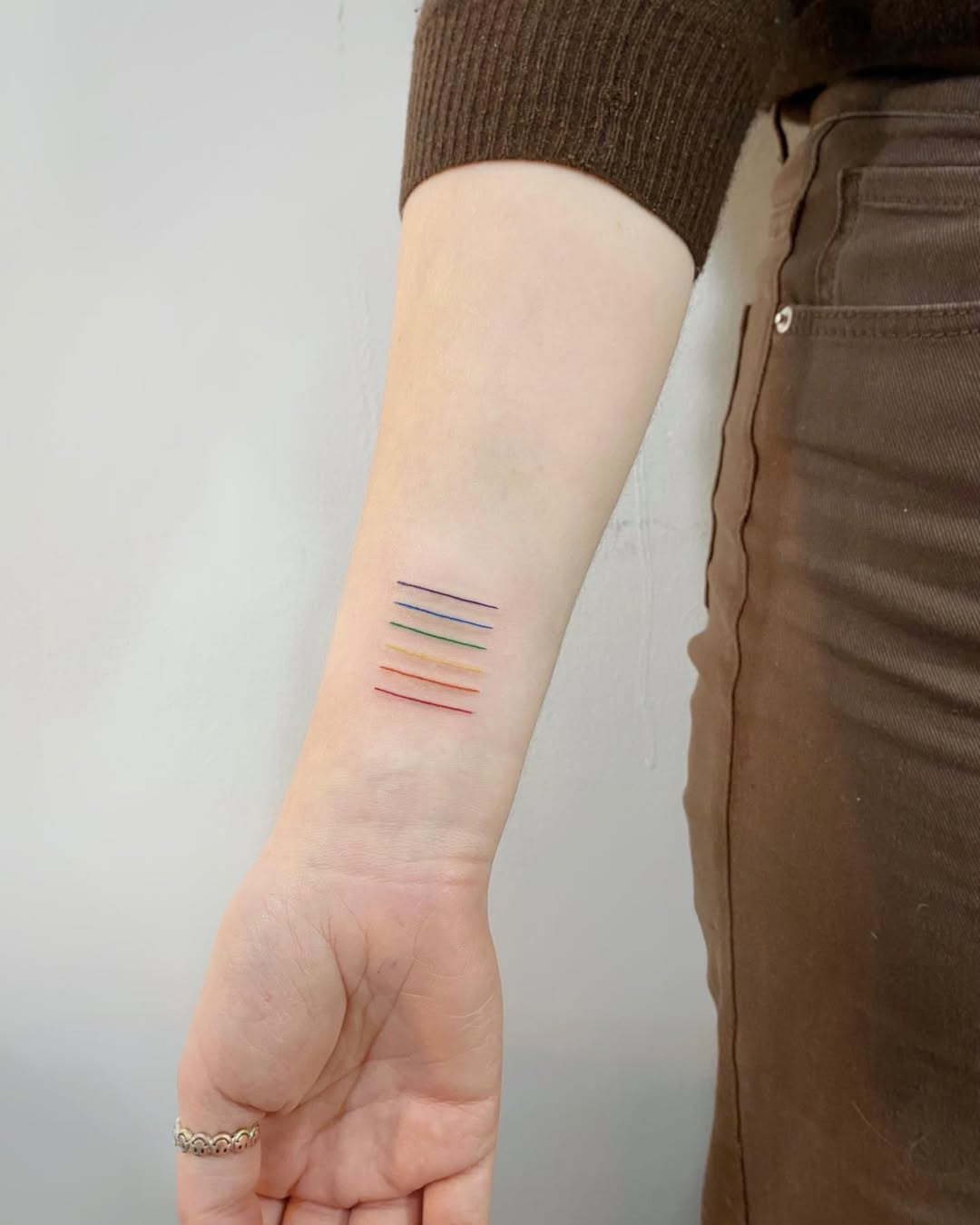 Elegant Minimalist Rainbow Line Tattoo Design