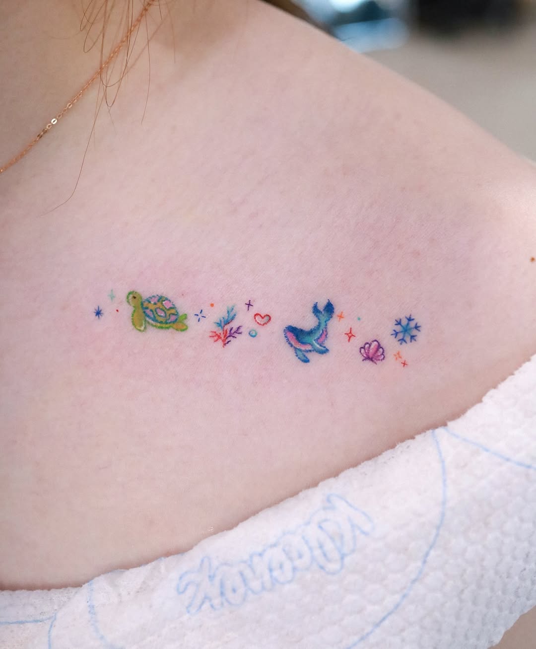 Charming minimalist whale tattoo with vibrant colors