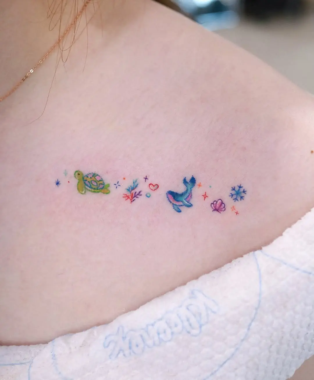 Charming minimalist whale tattoo with vibrant colors