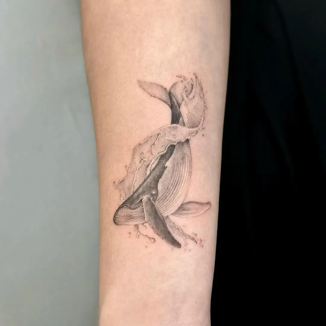 Elegant Whale Tattoo with Fluid Water Elements