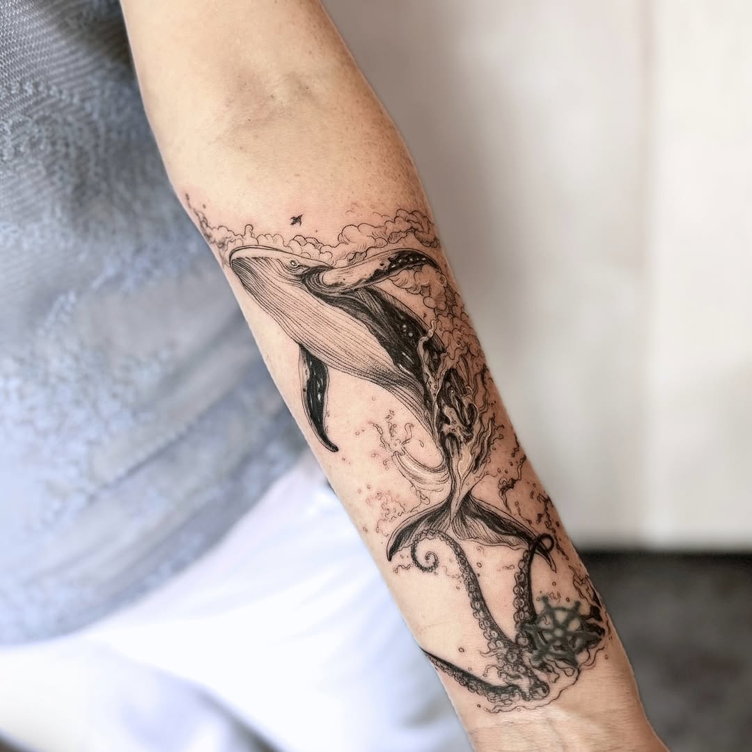 Elegant minimalist whale tattoo on the arm