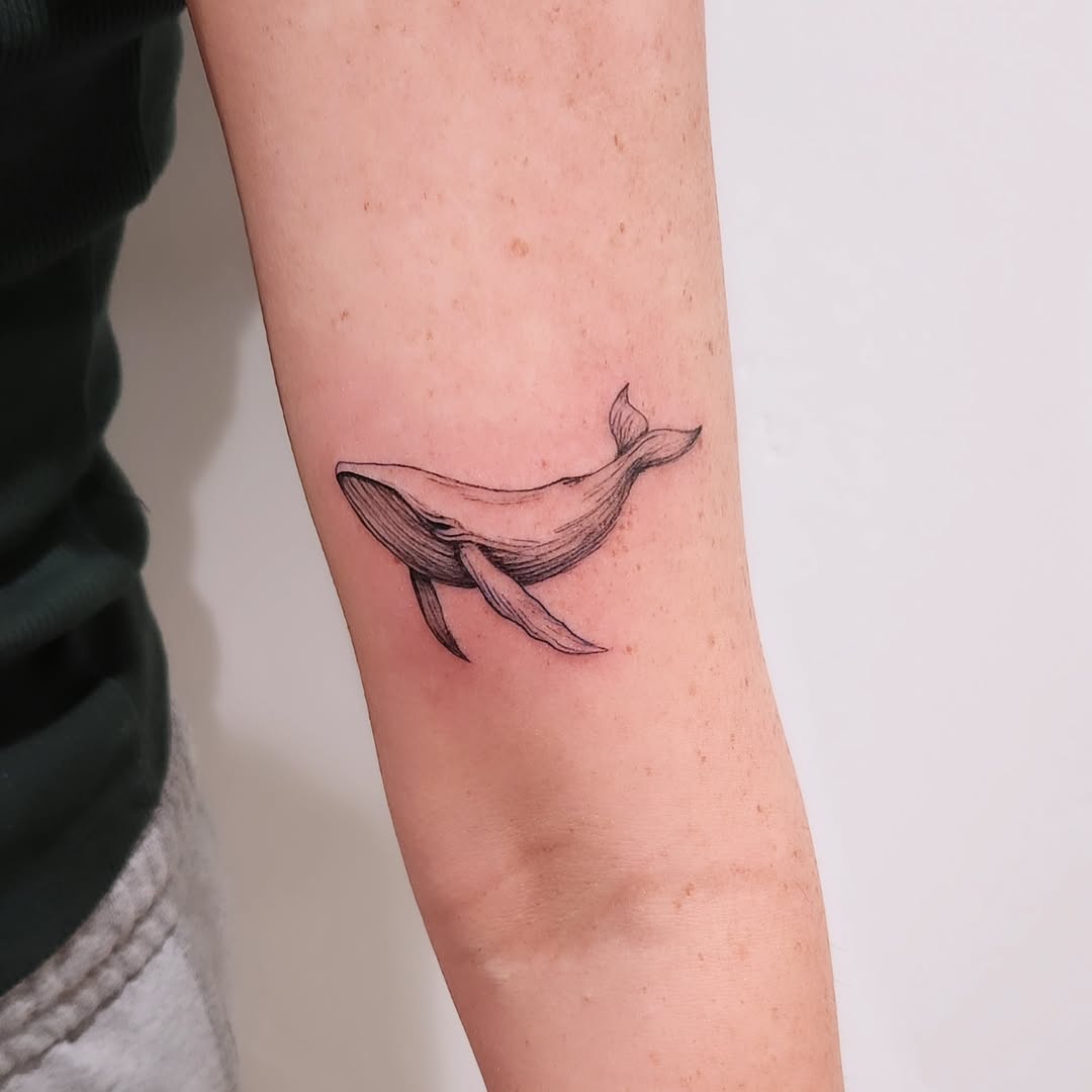 Elegant Fine Line Whale Tattoo on Arm