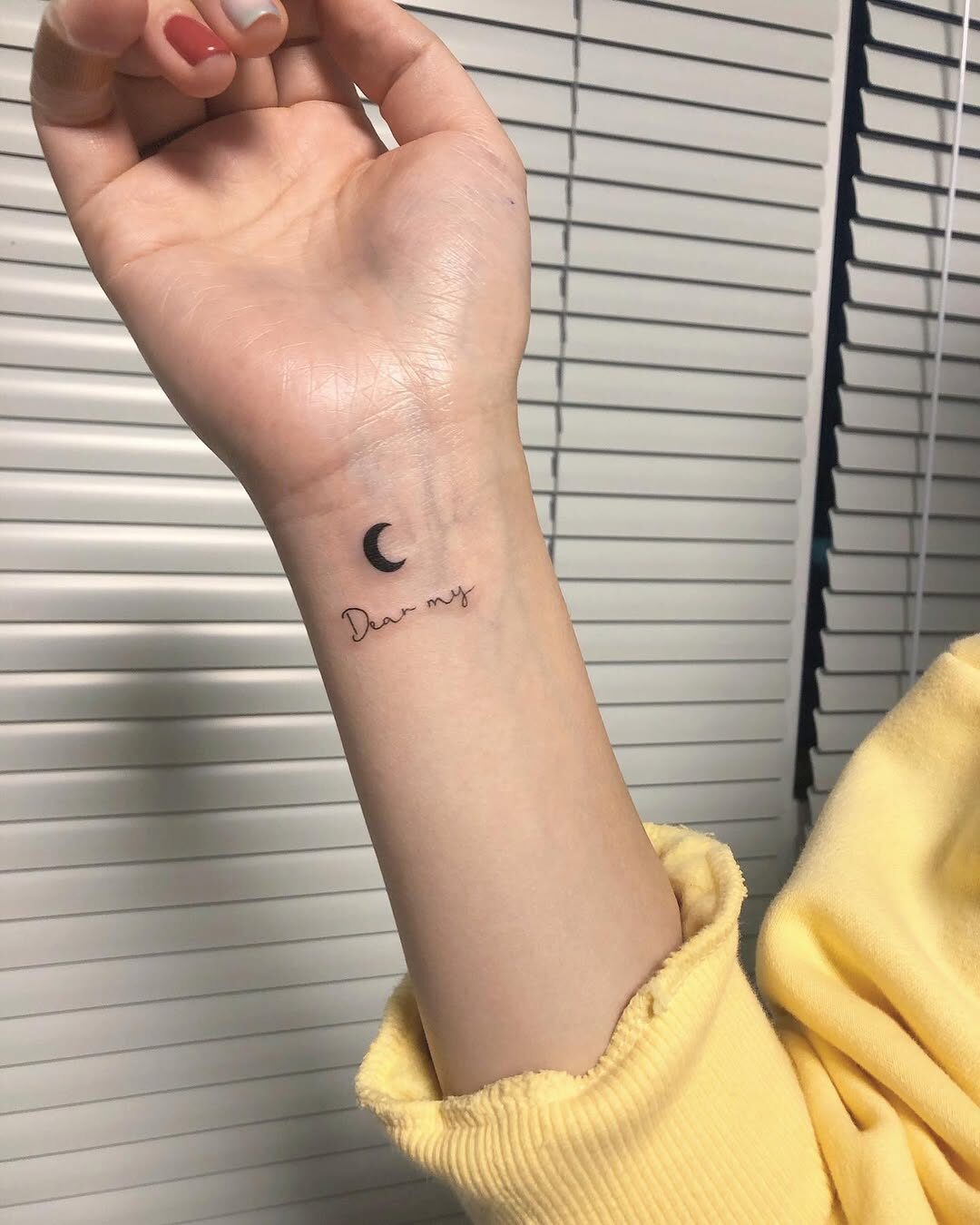 Exploring the Meaning Behind This Minimalist Moon Tattoo